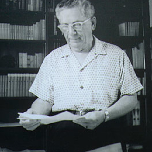 Joel Goldsmith Reading papers in his office